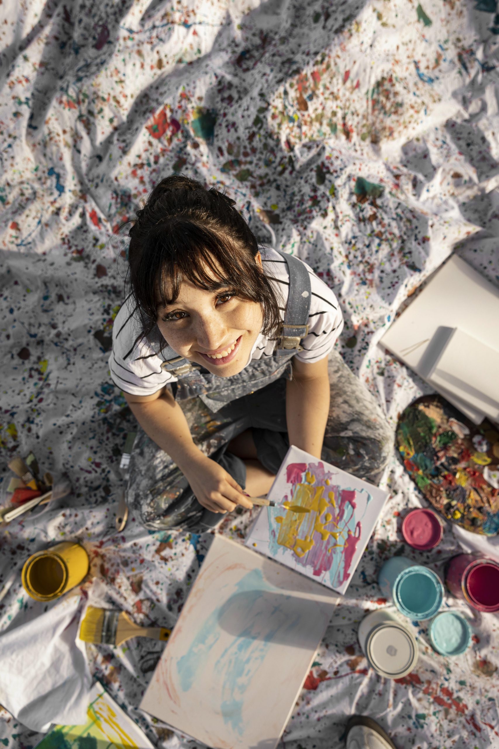 flat lay female painter outdoors with canvas