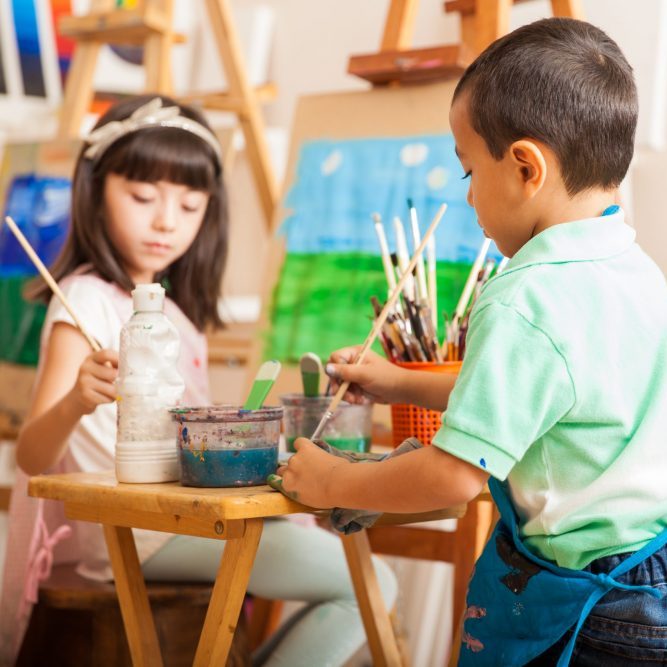 little kids working on a painting